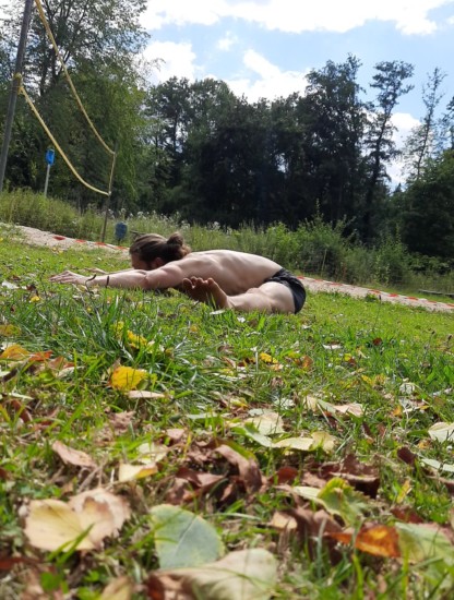 This image shows me training outdoors and performing a pancake stretch.