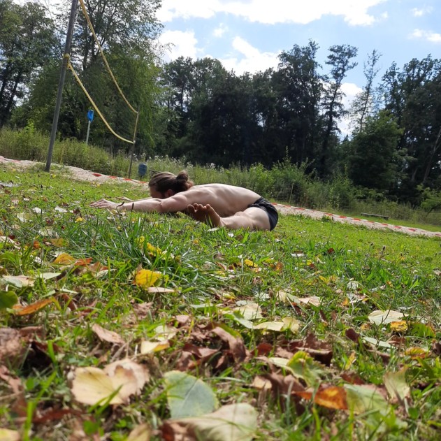 This image shows me training outdoors and performing a pancake stretch.