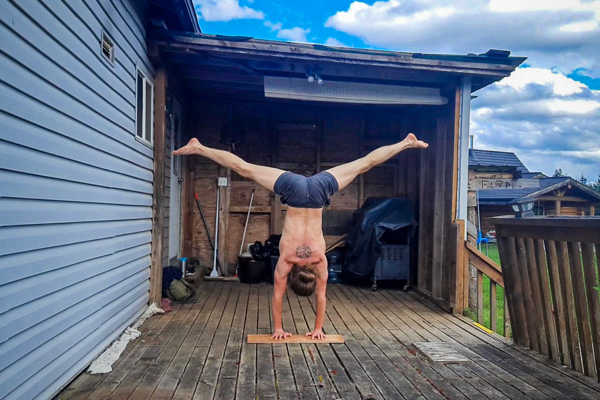 This image shows me doing a straddle handstand outdoors on a sunny day at Savanna Farms.