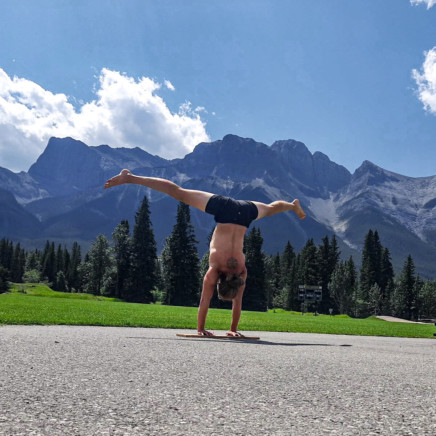 This image shows me doing a straddle handstand on a board in Canmore.