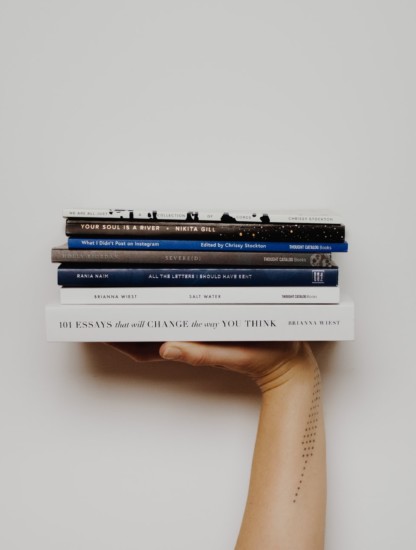 This image shows a stack of books to read on various topics.